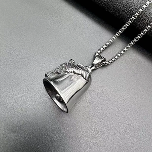 Macro shot of punk style titanium steel angel wing bell pendant with a box chain