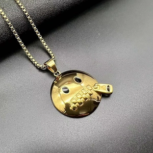 Macro detail of gold-plated Shut Up emoji pendant on a durable box chain necklace