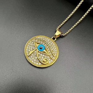 Macro detail of gold-plated Eye of Horus pendant with shimmering white cubic zirconia stones