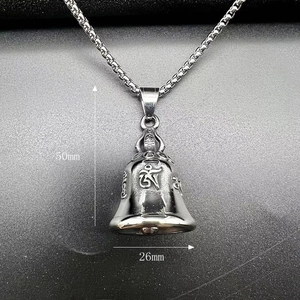 Macro shot of vintage titanium steel bell pendant with Sanskrit engraving and 50mm height