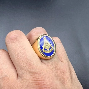 Detailed macro view of Freemasonry gold-plated signet ring with blue enamel and iconic logo