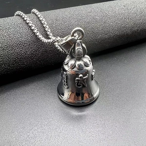 Close-up of titanium steel motorcycle bell pendant with engraved Buddhist scripture