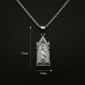 Detailed view of silver religious pendant with size dimensions 55mm by 19mm on a chain