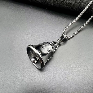 Detail of matte black biker bell pendant necklace with embossed Sanskrit characters