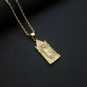 Macro detail of a golden Virgin Mary pendant with twisted rope chain on dark background