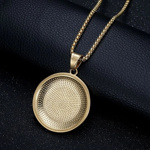 Macro shot of gold Eye of Horus pendant with textured inlay and polished box chain