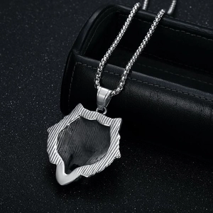 Detailed macro view of the textured fur pattern on a silver viking wolf head pendant