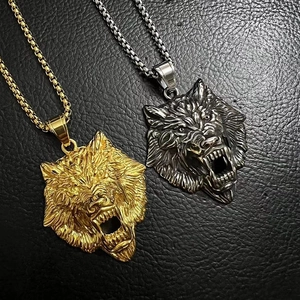 Close-up of gold and silver viking wolf head pendants with 3D embossed detail on box chains