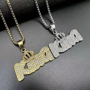 Macro view of gold and silver HIPHOP KING crown pendants with sparkling cubic zirconia