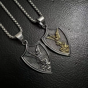 Detailed close-up of Saint Michael Archangel shield pendants in silver and gold finish
