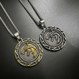 Macro detail of viking wolf head pendant necklace in silver and gold-tone finish