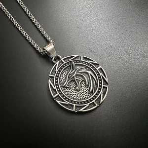 Detailed close-up of a Viking wolf head medallion with braided stainless steel chain