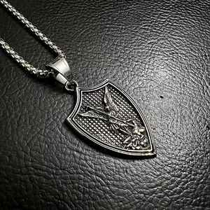 Macro detail of Archangel Saint Michael shield pendant in vintage silver on black leather