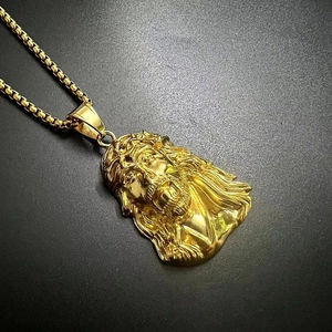 Detailed view of the gold Jesus head pendant with intricate facial carving and box chain