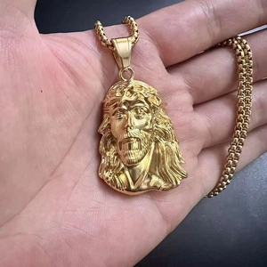 Polished gold Jesus portrait pendant necklace with sturdy box chain held in hand