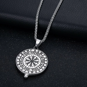 Macro shot of silver Viking Vegvisir compass pendant with ancient Nordic rune engravings