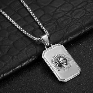 Macro shot of silver basketball pendant with sparkling crystals on black leather