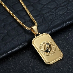 Detailed close-up of golden stainless steel American football pendant on a box chain