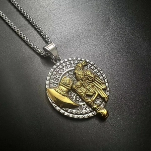 Macro view of Viking axe and Odin raven relief on a two-tone stainless steel pendant