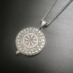 Detailed engraving of Viking Vegvísir compass and runic circles on silver steel pendant