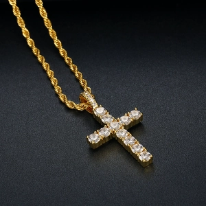 Macro detail of gold-plated cross pendant featuring 11 sparkling pavé-set zircon stones