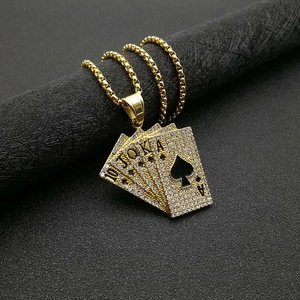 Detail of hip hop gold pendant with royal flush cards and sparkling white rhinestones