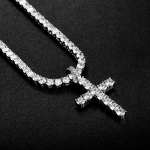 Macro shot of silver hip hop cross pendant with sparkling cubic zirconia on a tennis chain
