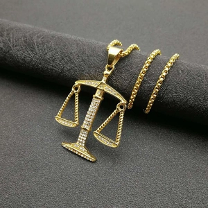 Gold-plated Libra zodiac scale pendant necklace with shimmering crystals on box chain