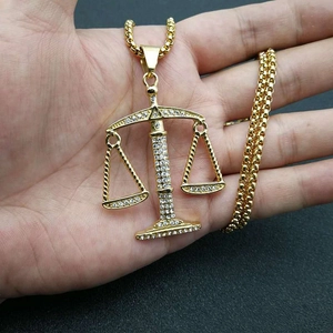 Gold-plated Libra zodiac scale pendant necklace with shimmering cubic zirconia stones