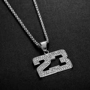 Détail du pendentif hip hop numéro 23 avec strass sertis sur une chaîne à maille vénitienne