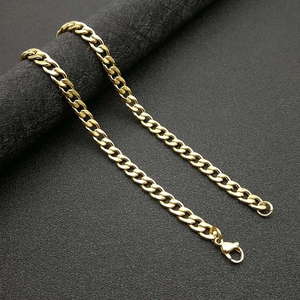 Polished gold plated Cuban link chain necklace with lobster clasp for men on black background