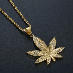 Gold-plated hip hop necklace featuring a maple leaf pendant with sparkling crystals