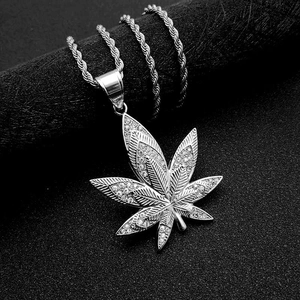 Macro view of crystal-encrusted cannabis leaf pendant with silver rope chain detail