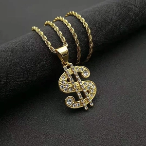 Macro shot of hip hop gold plated dollar sign pendant with shimmering iced out crystals