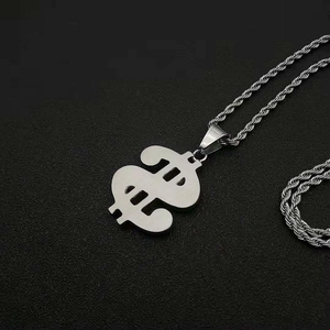 Macro shot of silver dollar sign pendant and heavy twisted chain in hiphop style