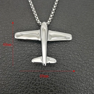 Detailed view of silver airplane pendant with size labels 40mm and 48mm on black leather