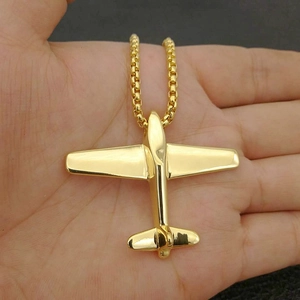 Gold plated airplane pendant necklace with round box chain held in hand for scale