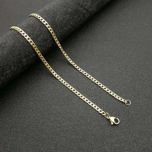 Polished gold curb chain necklace for men with lobster clasp on black leather background