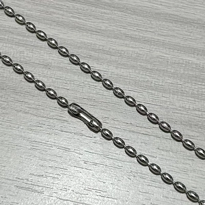 Detailed macro view of a 3mm stainless steel oval ball chain with tubular connector