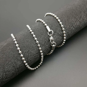 Close-up of polished stainless steel ball chain necklace with secure lobster clasp
