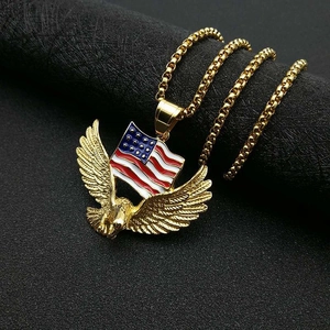 Detail shot of a gold-plated eagle holding the US flag pendant on a black cylinder