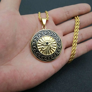 Gold Eye of Horus pendant necklace with black gemstone and twisted rope chain