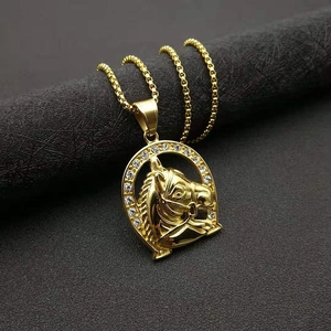 Iced out gold horse head pendant necklace with horseshoe frame on black display stand
