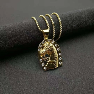 Gold horse head relief pendant necklace with horseshoe frame and sparkling crystals
