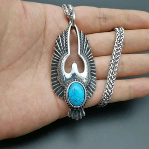 Eagle pendant necklace with turquoise stone inlay on a stainless steel woven chain