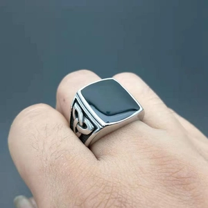 Polished titanium steel ring with black rectangular inlay and Celtic knot side carvings