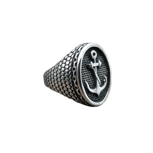 Polished stainless steel men's ring with nautical anchor relief and black mesh background