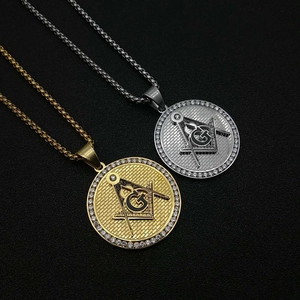 Macro detail of gold and silver Masonic AG pendants with micro-inlaid zircons on black fabric