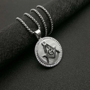 Detail macro of silver Masonic AG pendant with sparkling crystals and G symbol on chain