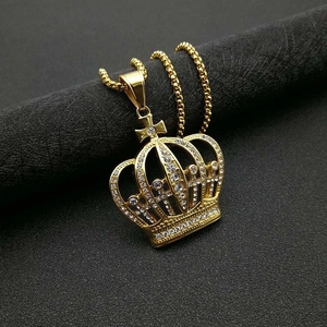 Gros plan d'un pendentif couronne hip-hop plaqué or serti de zircons et d'une croix
